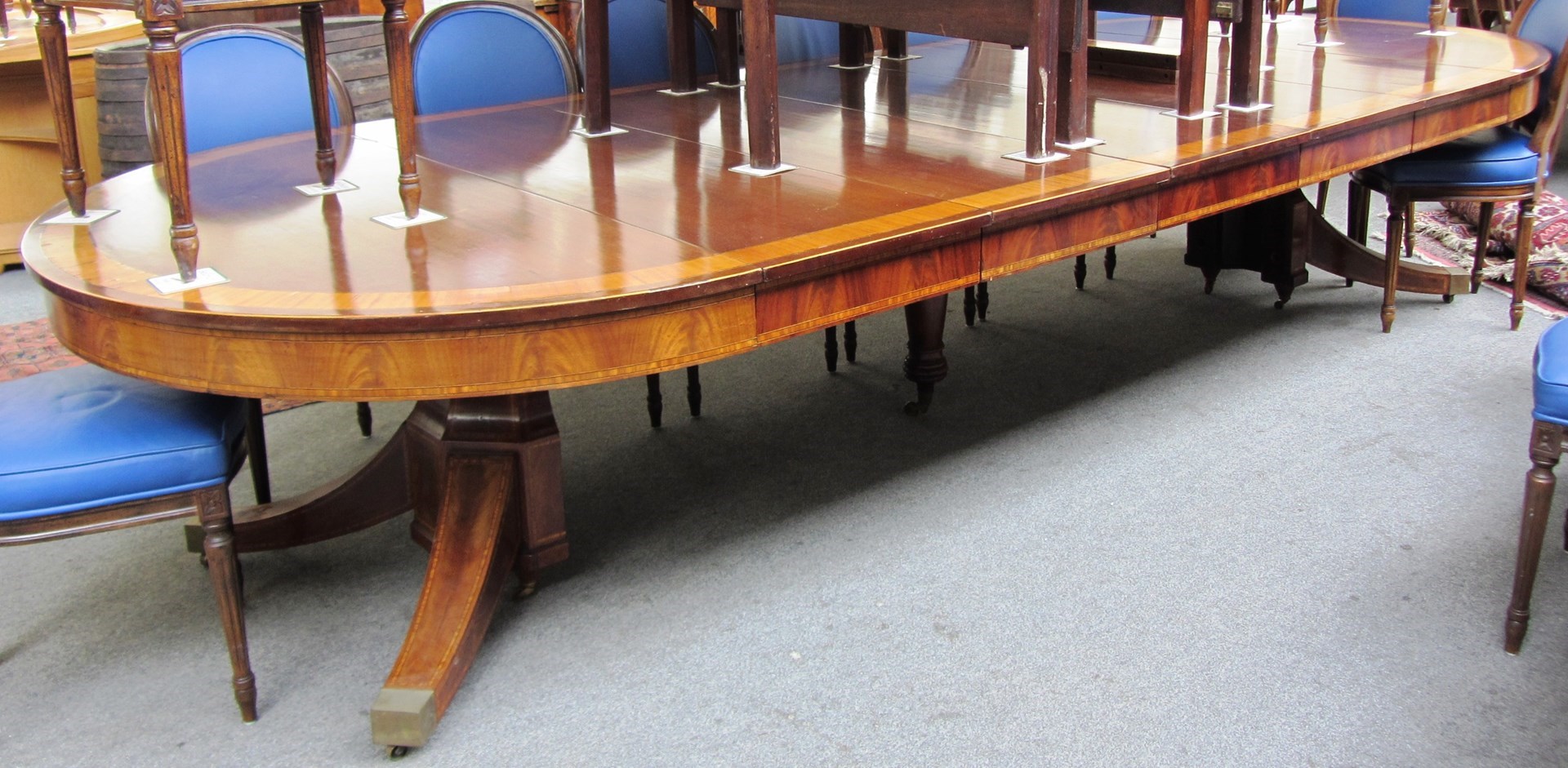 Appraisal: A late Victorian satinwood banded circular mahogany extending dining table