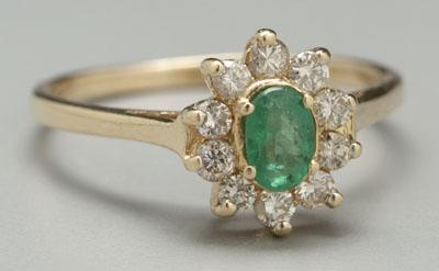 Appraisal: Emerald and diamond ring one oval-faceted emerald transparent medium intense