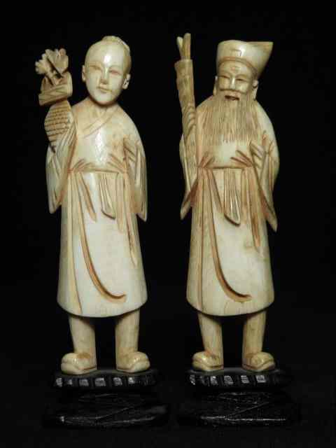 Appraisal: Two Japanese carved ivory figurines Both on small wooden stands