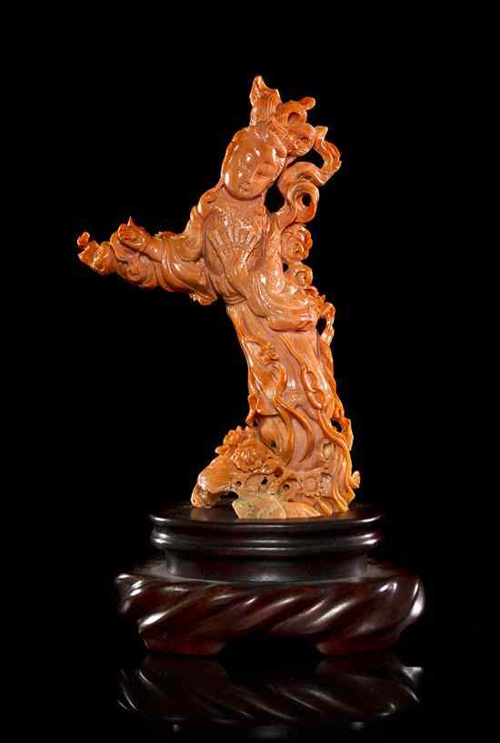 Appraisal: A Carved Coral Model of a Woman the figure depicted