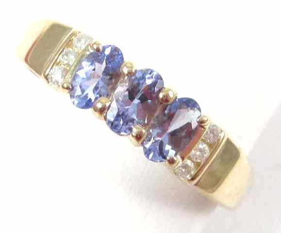 Appraisal: TANZANITE AND FOURTEEN KARAT GOLD RING set with six round-cut