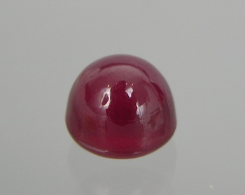 Appraisal: An Unset Transparent Ruby Cabochon Carat Cut as a sugarloaf