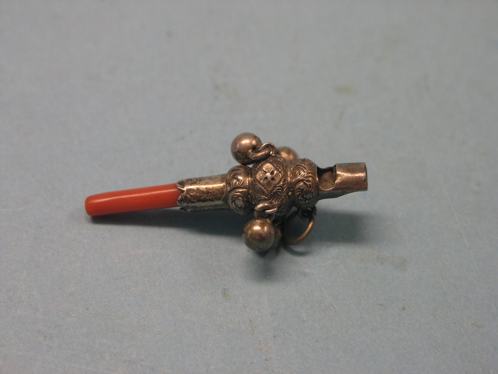 Appraisal: A Victorian Edwardian white metal baby rattle with integral whistle