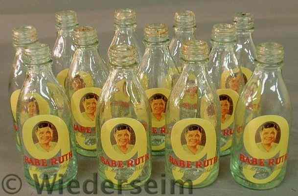 Appraisal: Twelve glass Babe Ruth bottles with paint decorated Babe Ruth