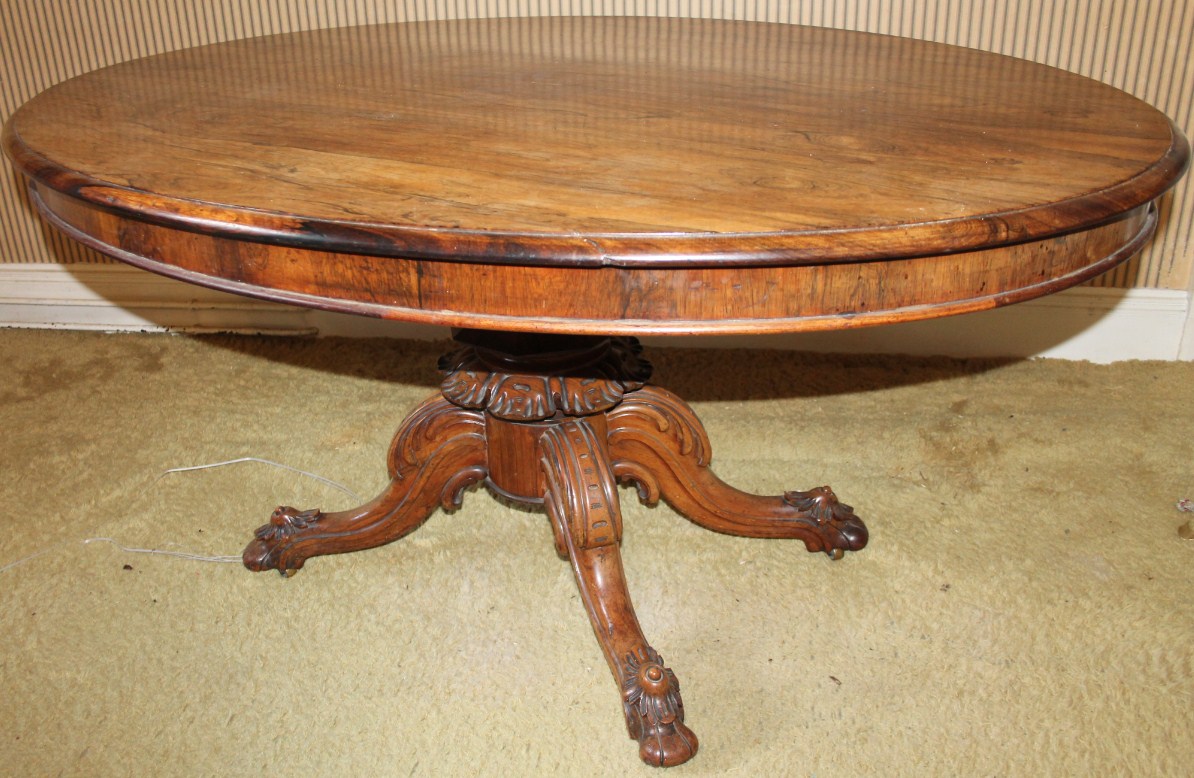 Appraisal: A Victorian rosewood oval breakfast table with moulded tilt top