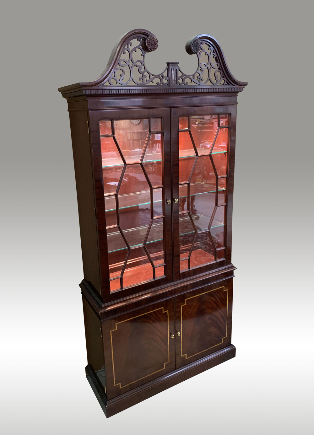 Appraisal: LIGHT MAHOGANY BOOKCASE CURIO CABINET Mahogany cabinet surmounted by a