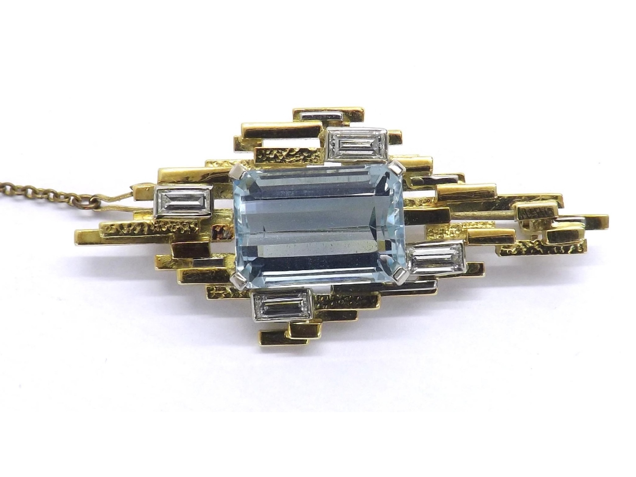 Appraisal: Good quality aquamarine and diamond abstract brooch the large emerald-cut