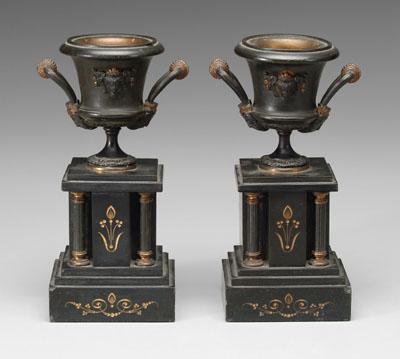 Appraisal: Pair cast metal urns patinated highlights bases with gilt intaglio