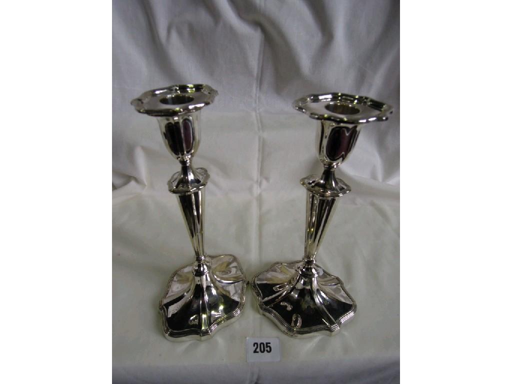 Appraisal: A pair of silver plated candlesticks of fluted form raised