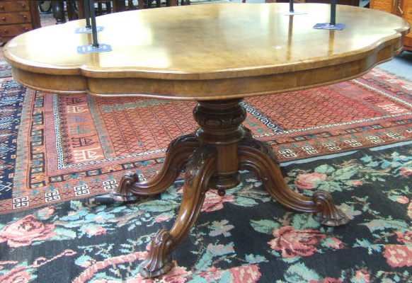 Appraisal: A Victorian figured walnut centre table the quarter veneered shaped