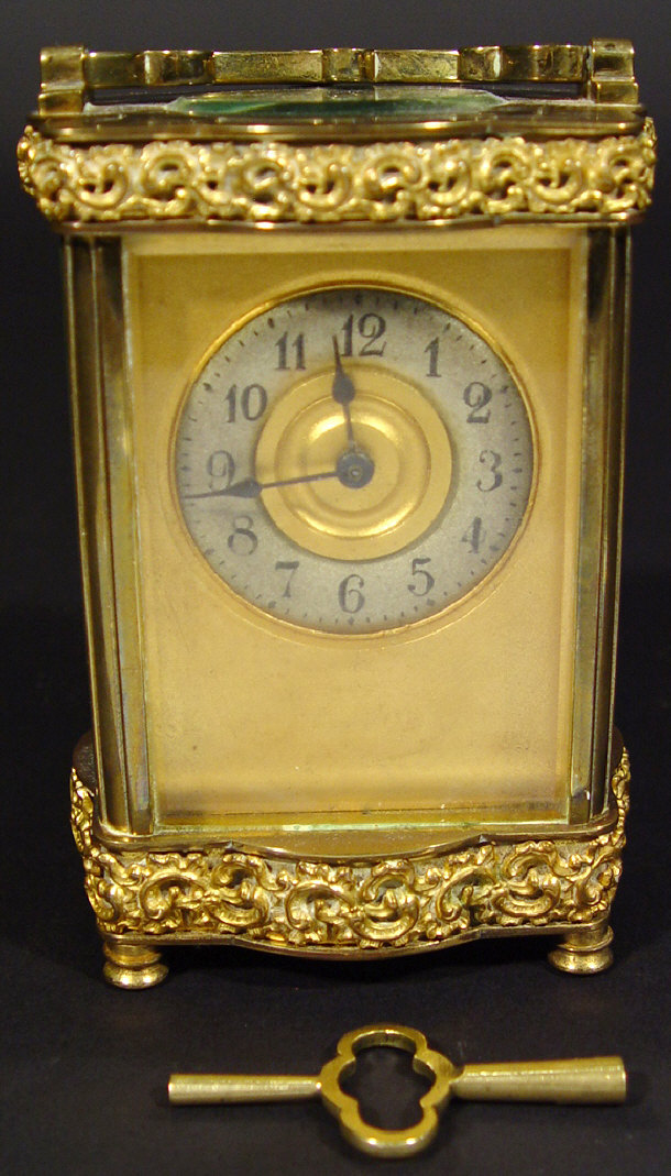 Appraisal: Brass carriage clock with bevelled glass panels and pierced mounts