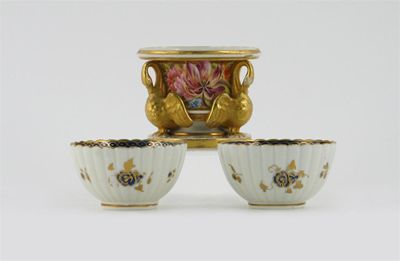 Appraisal: An English porcelain spill vase surrounded by three gilt swans