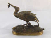 Appraisal: A brass figure of a wading bird with fish in