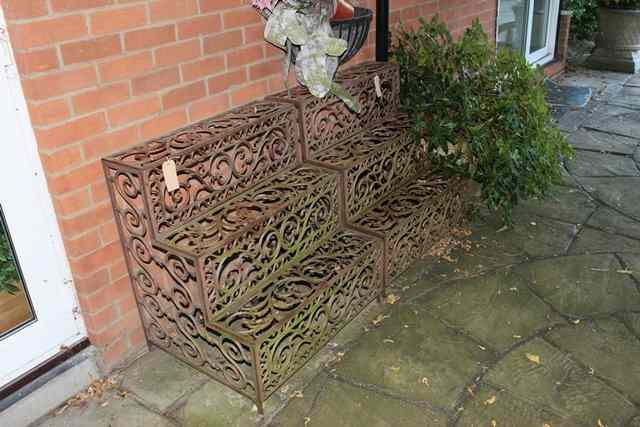 Appraisal: A PAIR OF CAST IRON STEPPED CONSERVATORY PLANT STANDS of