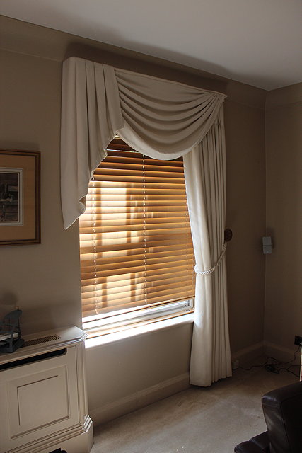 Appraisal: A PAIR OF CREAM INTERLINED CURTAINS together with a shaped