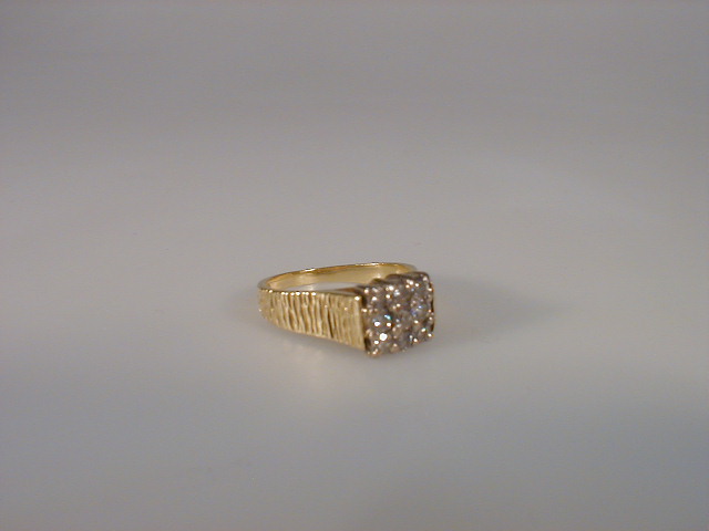 Appraisal: A ladies dress ring of nine tiny diamonds forming a