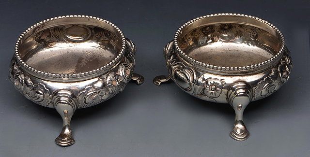 Appraisal: A PAIR OF VICTORIAN SILVER SALT CELLARS with embossed decoration