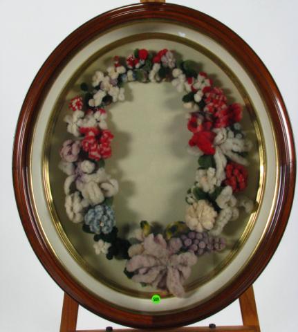 Appraisal: Antique oval-framed Victorian yarn wreath in x oval shadow box