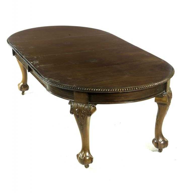 Appraisal: A WALNUT DINING TABLE the top with two leaves and