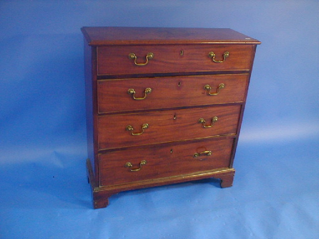 Appraisal: A George III mahogany shallow chest of four graduated drawers