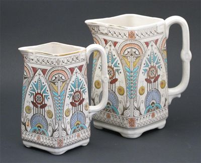 Appraisal: Two graduated Old Hall jugs designed by Dr Christopher Dresser