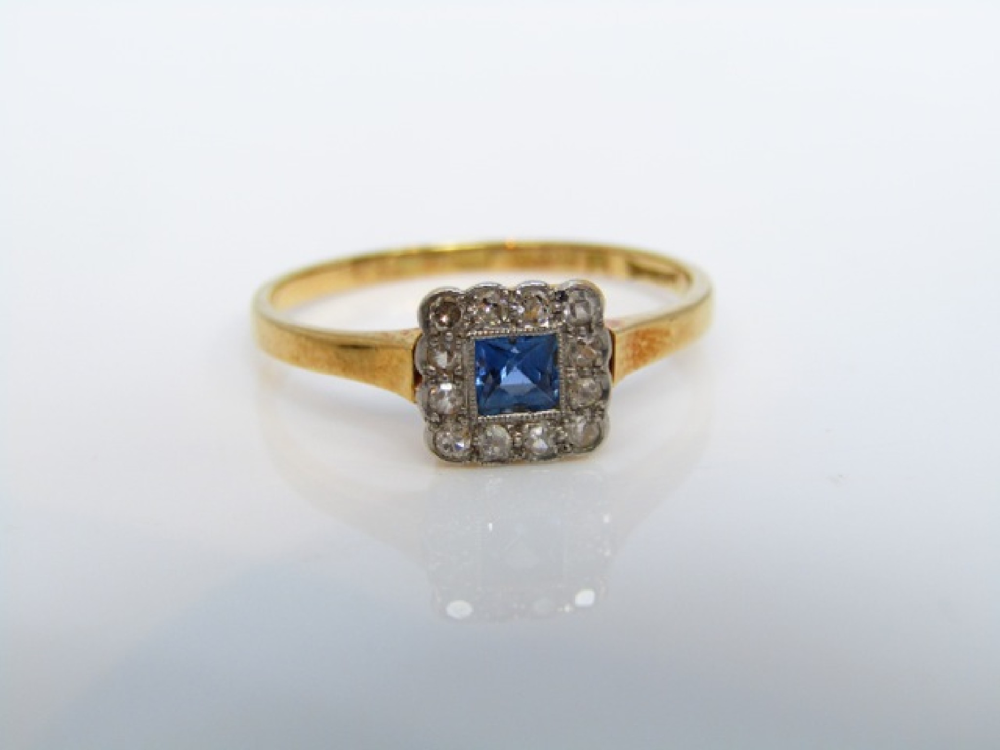 Appraisal: A sapphire and diamond ring centred with a square-cut untested