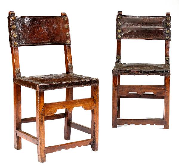 Appraisal: A pair of Spanish Baroque brass mounted walnut and leather