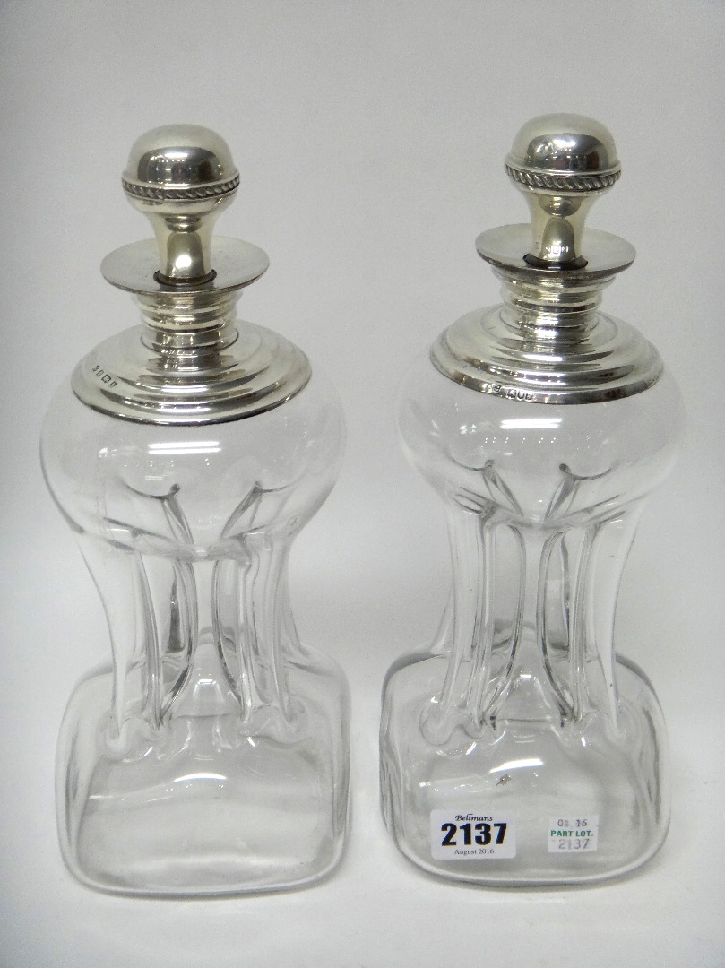 Appraisal: Two similar silver mounted dimple shaped glass decanters and stoppers