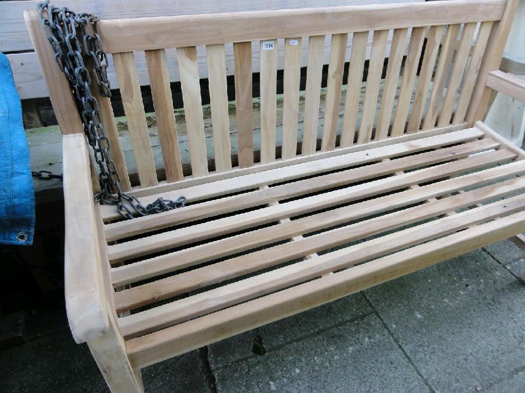 Appraisal: A contemporary teakwood garden bench with slatted seat and back