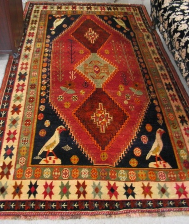 Appraisal: PERSIAN SHIRAZ CARPET centering a column of three geometric medallions