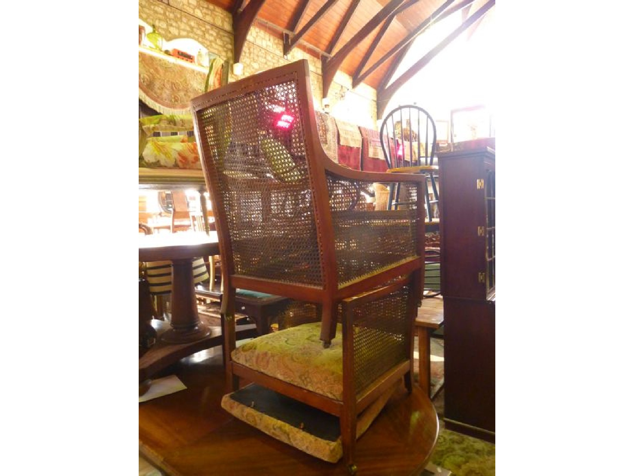 Appraisal: A pair of Edwardian mahogany bergere armchairs with drop in