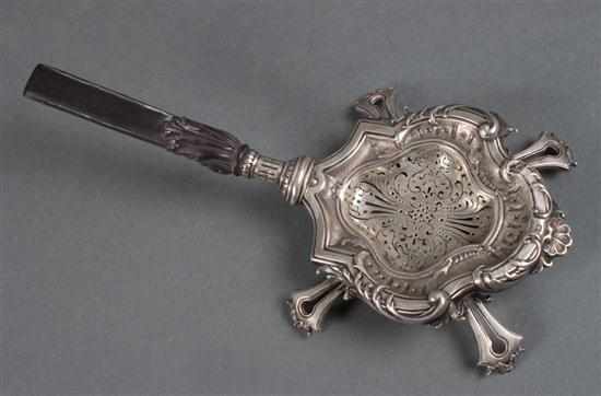 Appraisal: German rococo style chased silver tea strainer with carved horn