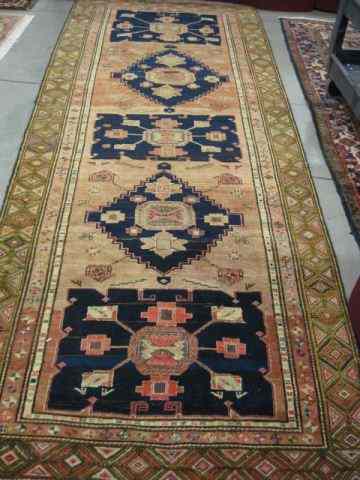 Appraisal: Meshkin Persian Handmade Rug earthtones with blue around geometric designs