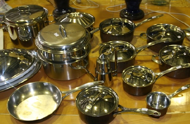 Appraisal: A collection of pots and pans in copper and stainless