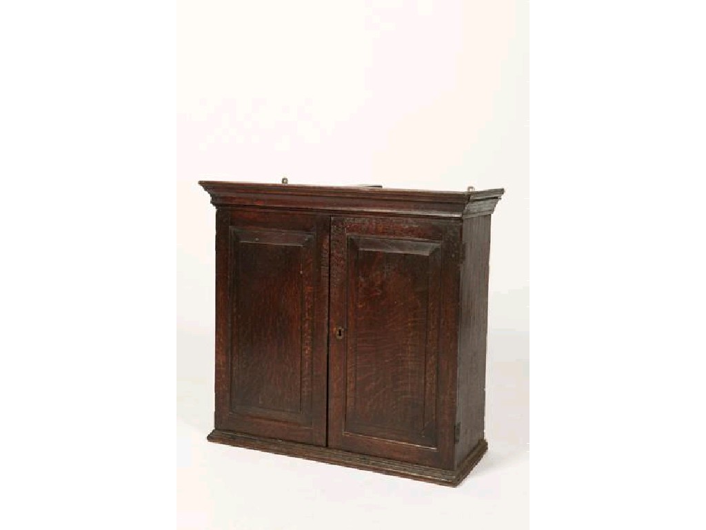 Appraisal: A GEORGE III OAK WALL CUPBOARD with a moulded cornice