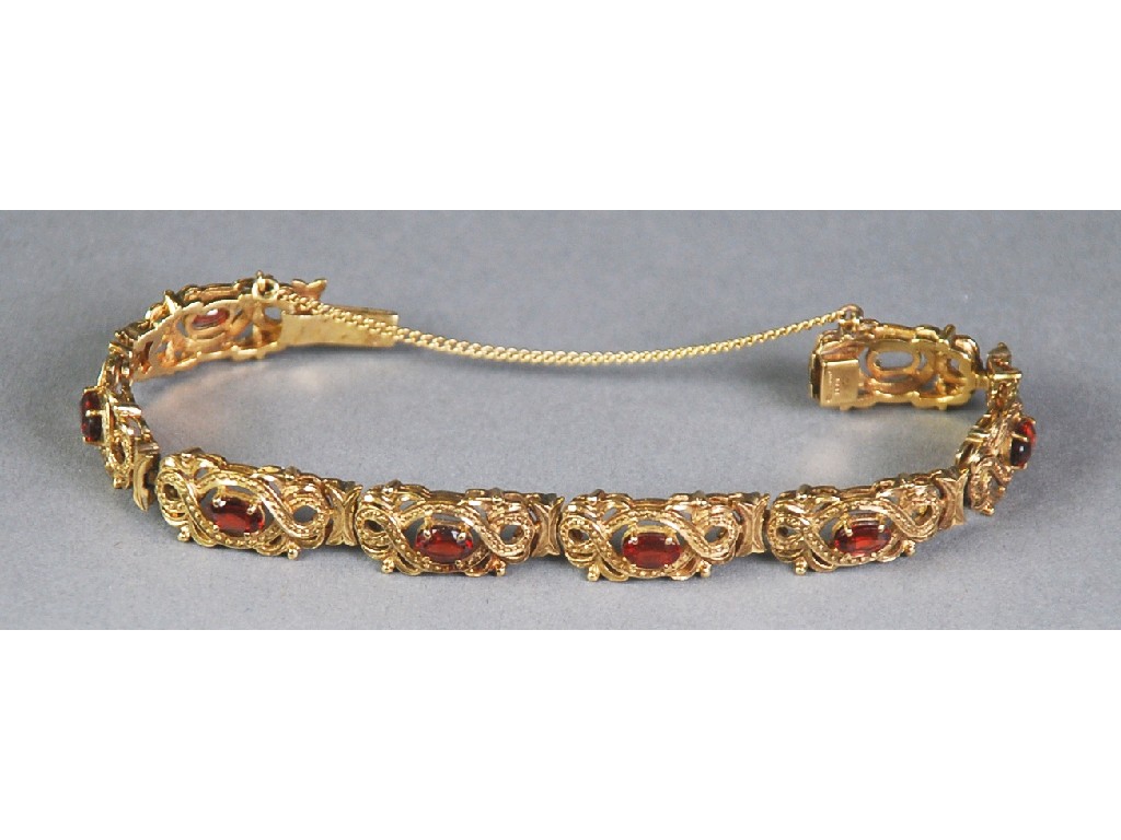 Appraisal: ct GOLD AND GARNET BRACELET with light openwork scroll panel