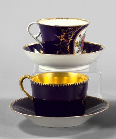 Appraisal: Two Cobalt-Ground Porcelain Cups and Saucers consisting of a fine