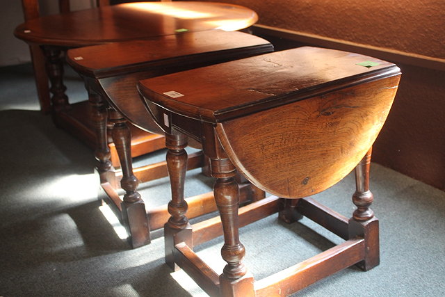 Appraisal: TWO SMALL OAK REPRODUCTION DROP-LEAF OCCASIONAL TABLES and a similar