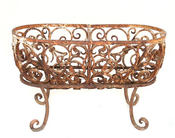 Appraisal: A wrought iron pierced oval jardiniere on stand together with