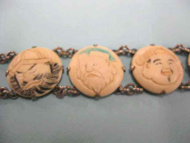 Appraisal: Japanese Carved Ivory Sterling Bracelet fancy polychromed faces '' long