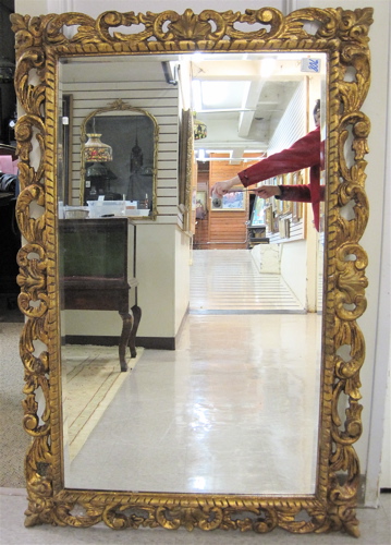 Appraisal: A FRENCH WALL MIRROR The gilt pierced-carved rectangular frame having