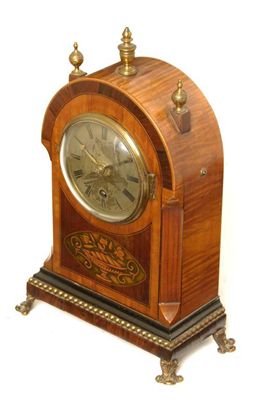 Appraisal: A satinwood rosewood marquetry mantle clock with a single barrel