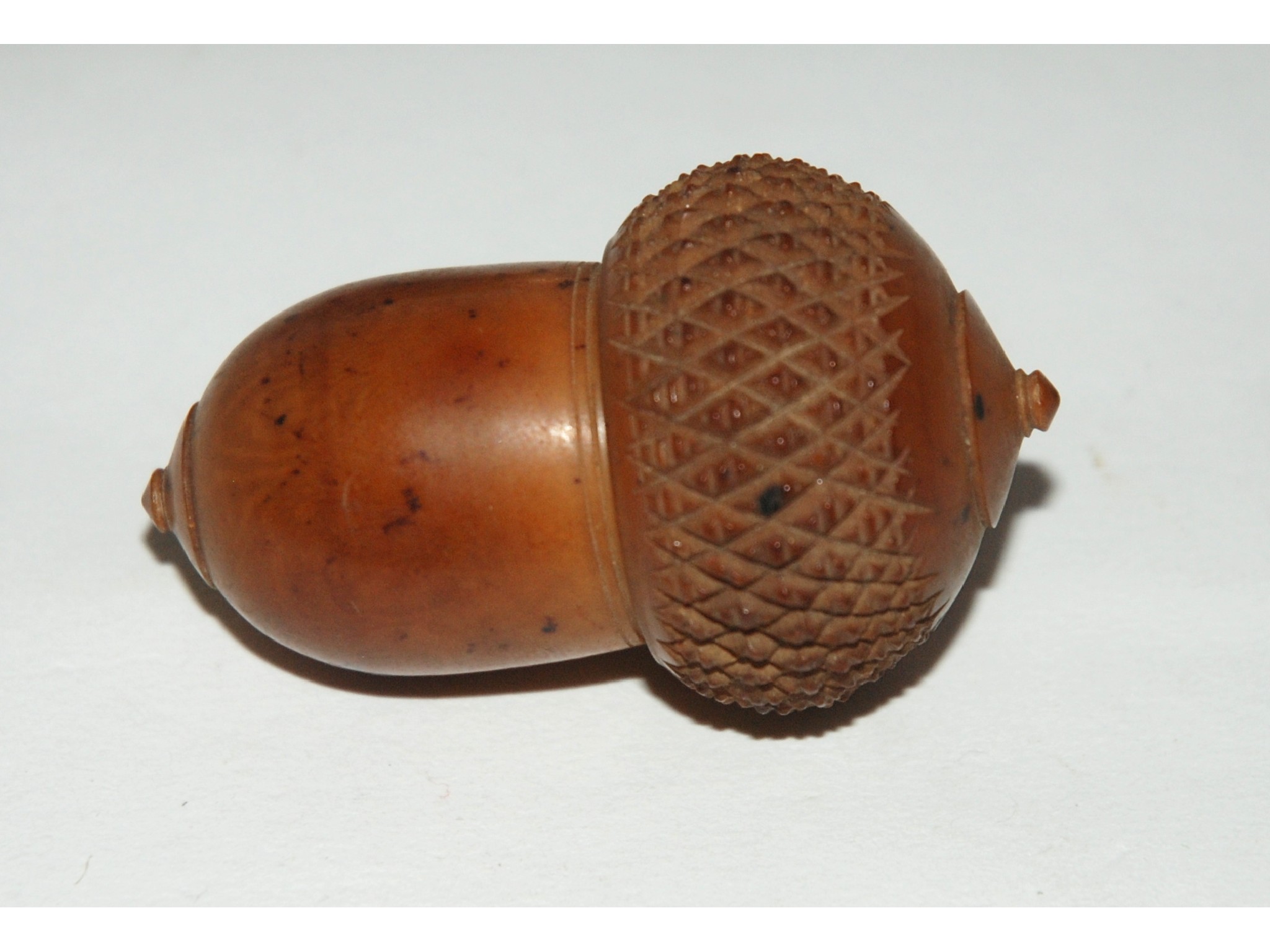 Appraisal: A treen bobbin formed as an acorn a treen circular