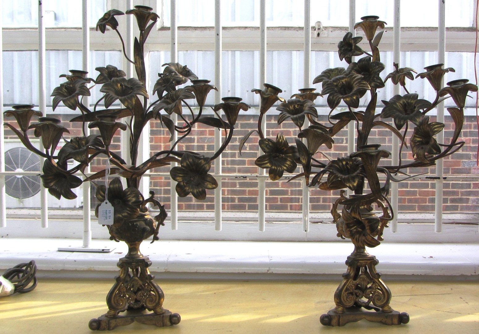 Appraisal: A pair of Victorian gilt brass candelabra each modelled and