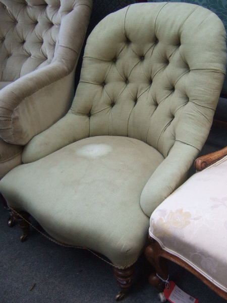 Appraisal: A Victorian walnut framed button back nursing chair with serpentine