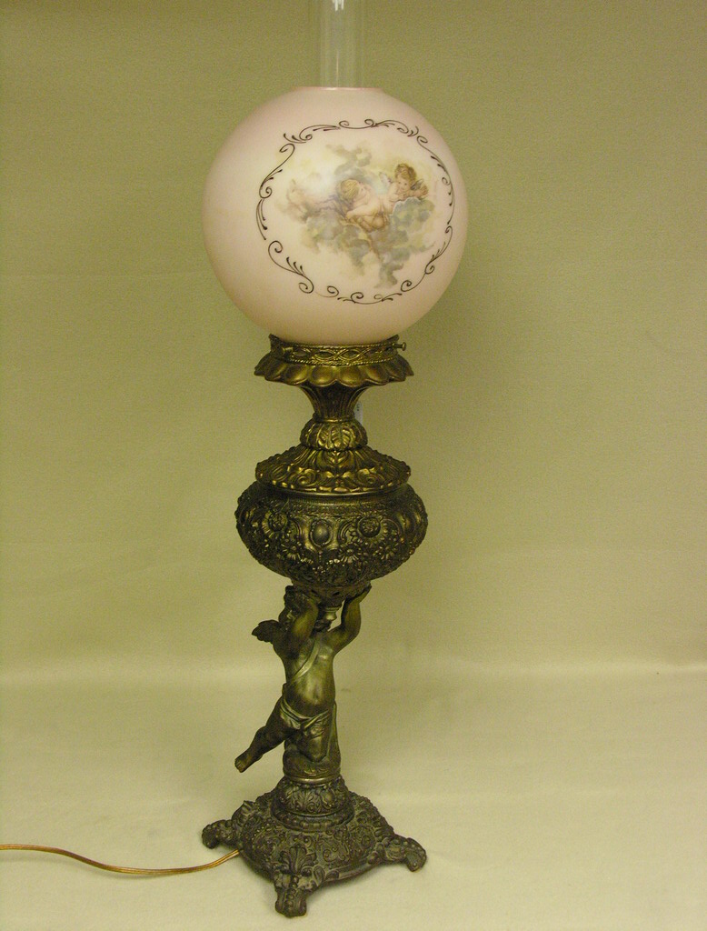 Appraisal: VICTORIAN CHERUB BASE PARLOR LAMP Electrified Size with sq base