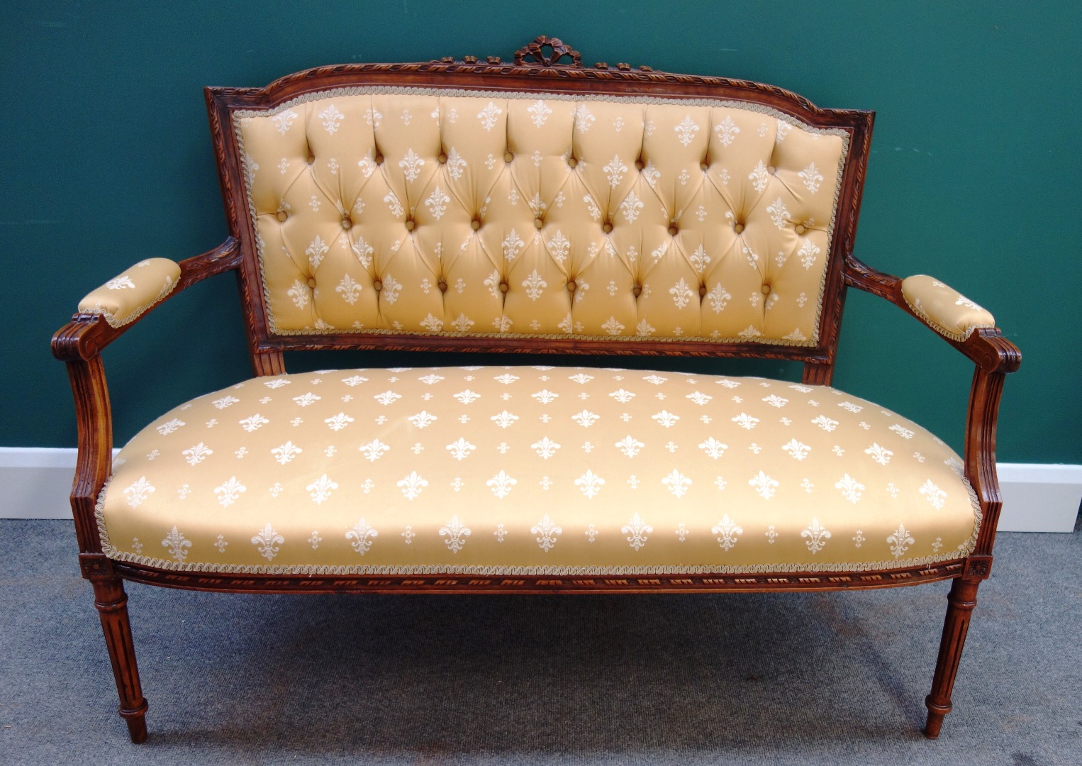 Appraisal: A Louis XVI style walnut framed open arm sofa on