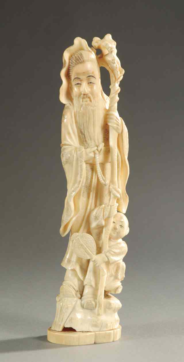 Appraisal: CHINESE IVORY CARVED FIGURE man standing holding staff with young