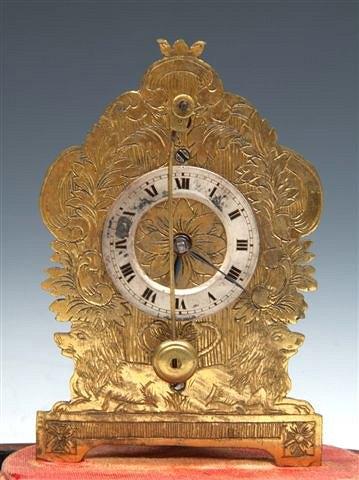 Appraisal: A MINIATURE CLOCK under a dome with a pendulum to