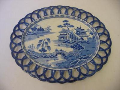 Appraisal: AN ENGLISH EARTHENWARE RIBBON PLATE with pierced blue border blue